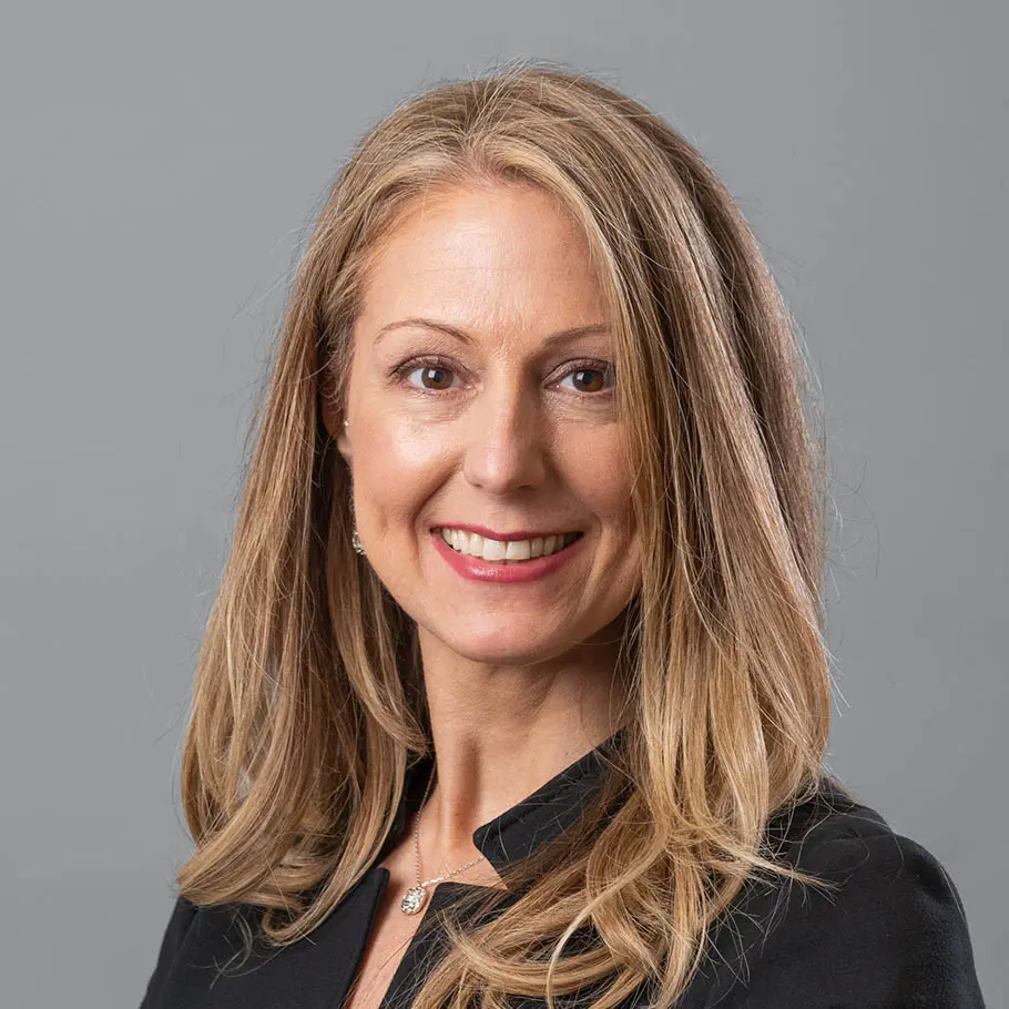 A woman with long blonde hair wearing black shirt.