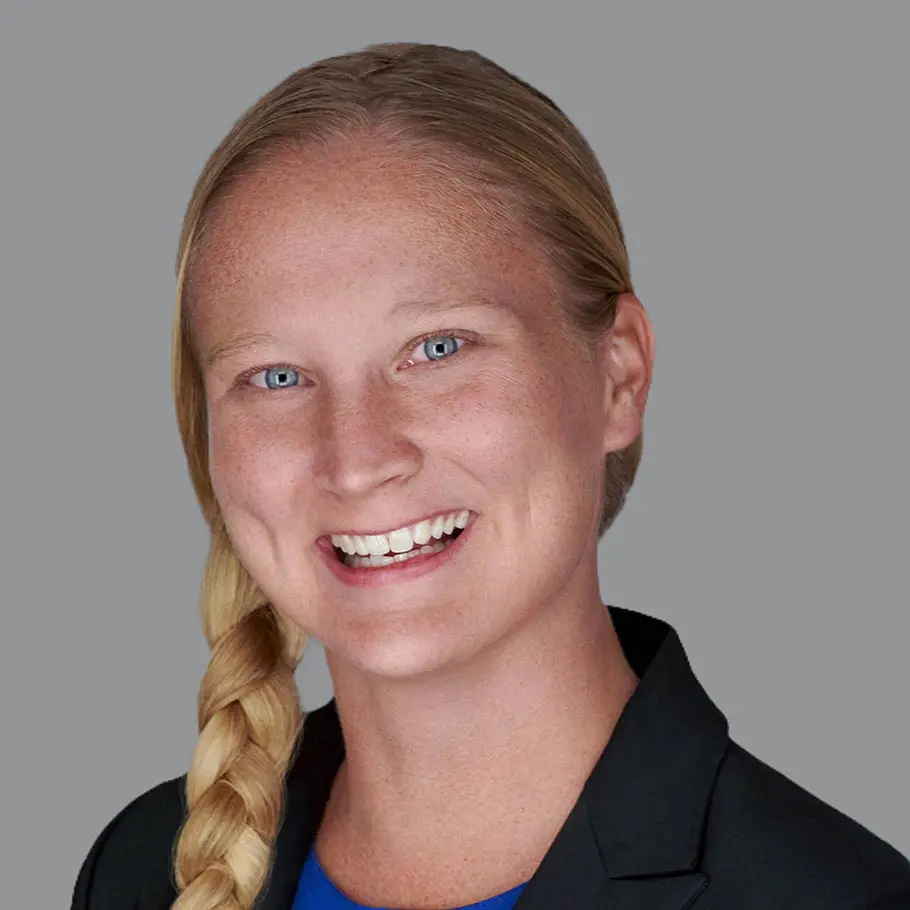 A woman with long blonde hair and a blue shirt.