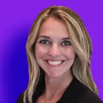 A woman with long blonde hair smiles for the camera.