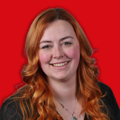 Smiling woman with long red hair.