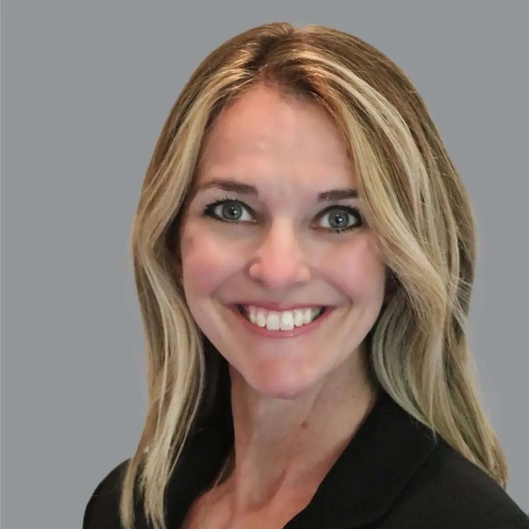 Smiling woman with blonde hair and black shirt.