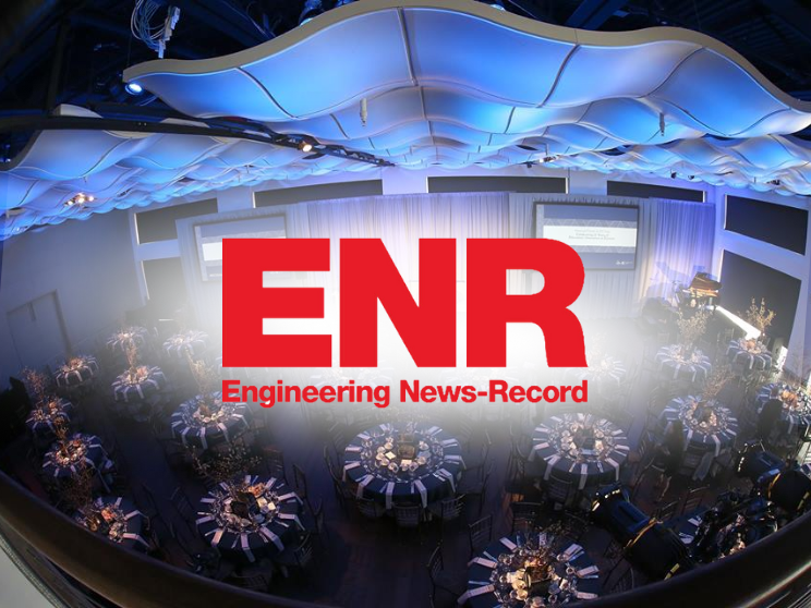 ENR logo with tables and chairs in a room.