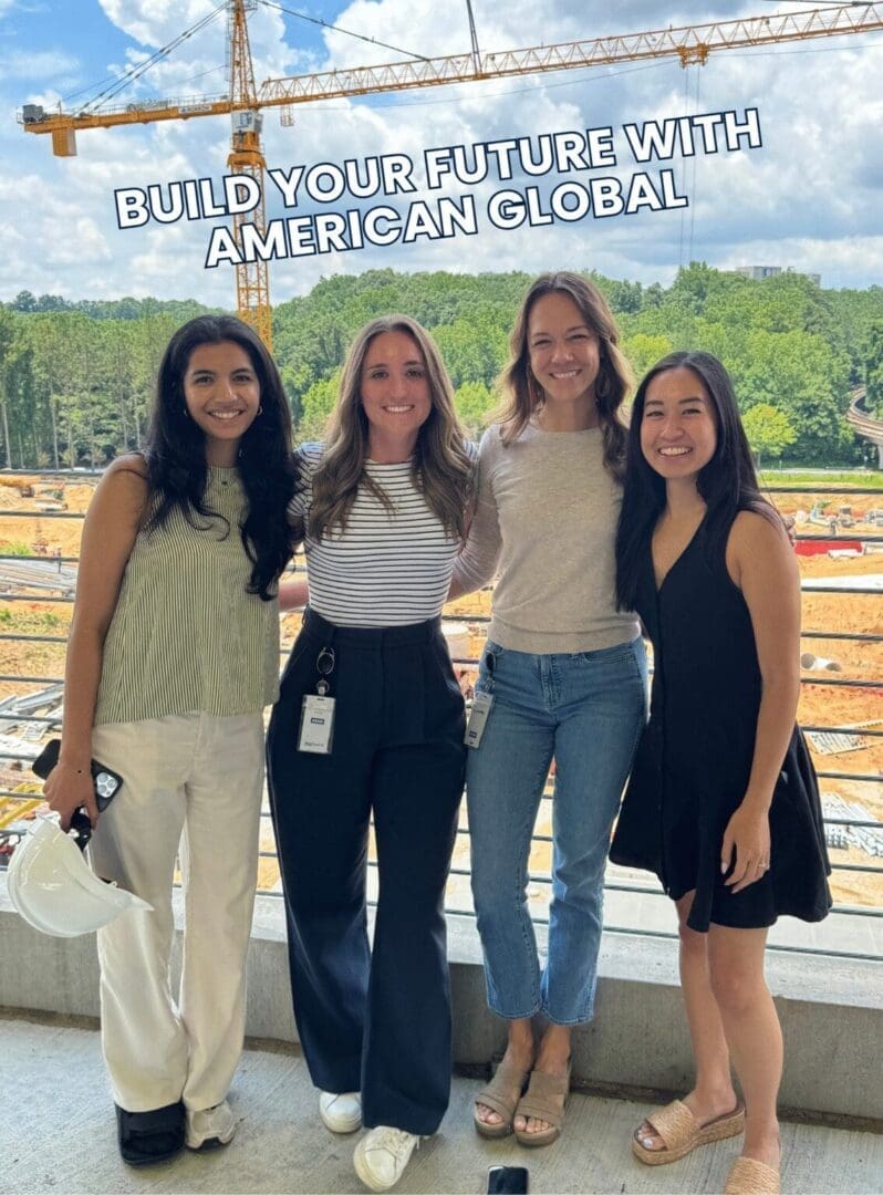 Four women posing at construction site.