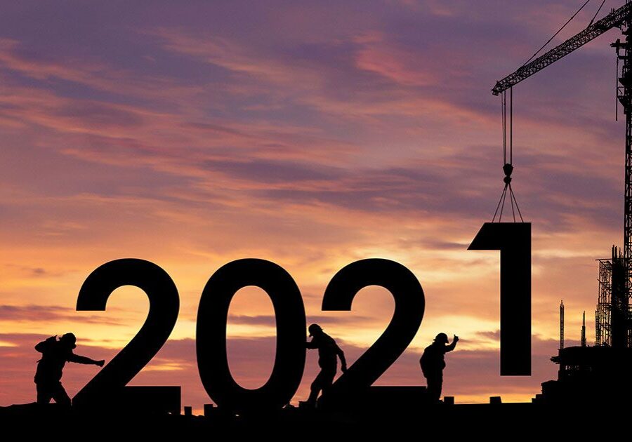 Silhouettes of workers building 2021.